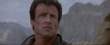 Movie still from “Cliffhanger” (1993), directed by Renny Harlin – Sylvester stallone in rambo : first blood part ii; Close Up shot, Low angle