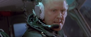 Movie still from “Cliffhanger” (1993), directed by Renny Harlin – An older man wearing a headset and a jacket; Close Up shot, Low angle