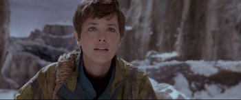 Movie still from “Cliffhanger” (1993), directed by Renny Harlin – A young woman in a jacket looking into the distance; Close Up shot, Low angle