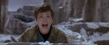 Movie still from “Cliffhanger” (1993), directed by Renny Harlin – A young boy is sitting in the snow and making a funny face; Close Up shot, Low angle