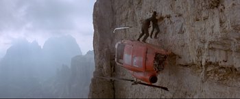 Movie still from “Cliffhanger” (1993), directed by Renny Harlin – Two men are climbing up the side of a cliff; Wide shot, High angle