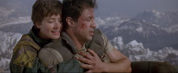 Movie still from “Cliffhanger” (1993), directed by Renny Harlin – A man and a woman with blood on their face and chest; Close Up shot, Low angle