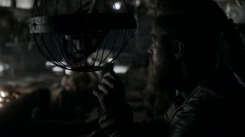 Movie still from “Vikings” (2013), created by Michael Hirst – A man with a beard is looking at a fan; Close Up shot, Over the shoulder angle