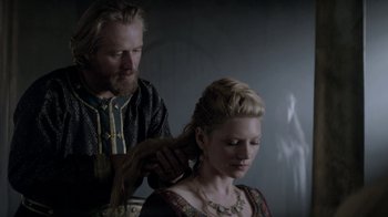 Movie still from “Vikings” (2013), created by Michael Hirst – A man and a woman are combing each other's hair; Close Up shot, Over the shoulder angle