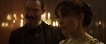 Movie still from “Colette” (2018), directed by Wash Westmoreland – A man and a woman in front of candles; Close Up shot, Over the shoulder angle