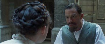 Movie still from “Colette” (2018), directed by Wash Westmoreland – A man and a woman looking at each other in a mirror; Close Up shot, Over the shoulder angle