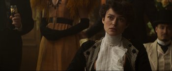Movie still from “Colette” (2018), directed by Wash Westmoreland – A person wearing a dress; Close Up shot, Over the shoulder angle