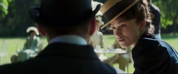 Movie still from “Colette” (2018), directed by Wash Westmoreland – A man and a woman wearing hats and a suit; Close Up shot, Over the shoulder angle