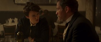 Movie still from “Colette” (2018), directed by Wash Westmoreland – A man and a woman sitting at a table talking to each other; Close Up shot, Over the shoulder angle