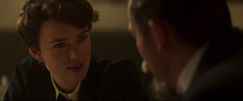 Movie still from “Colette” (2018), directed by Wash Westmoreland – A man and a woman sitting in front of each other; Close Up shot, Over the shoulder angle