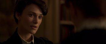 Movie still from “Colette” (2018), directed by Wash Westmoreland – A person wearing a suit and tie; Close Up shot, Over the shoulder angle