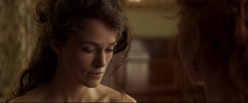 Movie still from “Colette” (2018), directed by Wash Westmoreland – A woman's face in a dark room; Close Up shot, Over the shoulder angle