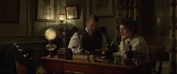 Movie still from “Colette” (2018), directed by Wash Westmoreland – A man and a woman sitting at a table; Medium shot, Over the shoulder angle