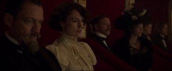 Movie still from “Colette” (2018), directed by Wash Westmoreland – A woman in a white dress and a man in a black suit; Close Up shot, Over the shoulder angle
