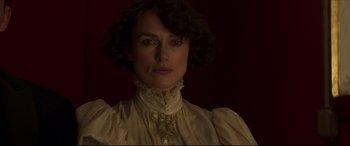 Movie still from “Colette” (2018), directed by Wash Westmoreland – A person wearing a dress; Close Up shot, Over the shoulder angle