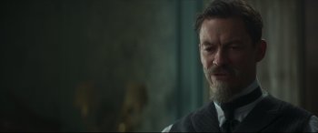 Movie still from “Colette” (2018), directed by Wash Westmoreland – A person wearing a suit and tie; Close Up shot, Over the shoulder angle