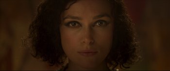 Movie still from “Colette” (2018), directed by Wash Westmoreland – A woman's face in the dark; Close Up shot, Overhead angle