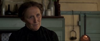 Movie still from “Colette” (2018), directed by Wash Westmoreland – An older woman wearing a black shirt and a black dress; Close Up shot, Over the shoulder angle