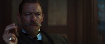 Movie still from “Colette” (2018), directed by Wash Westmoreland – A person wearing a suit and tie; Close Up shot, Low angle