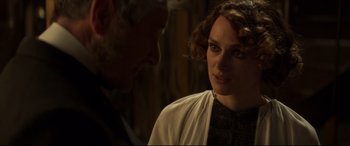 Movie still from “Colette” (2018), directed by Wash Westmoreland – A man and a woman looking at one another; Close Up shot, Over the shoulder angle