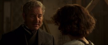 Movie still from “Colette” (2018), directed by Wash Westmoreland – An older man in a suit talking to a younger woman; Close Up shot, Over the shoulder angle