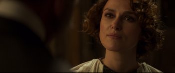 Movie still from “Colette” (2018), directed by Wash Westmoreland – A person wearing a white shirt; Close Up shot, Over the shoulder angle