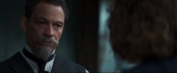 Movie still from “Colette” (2018), directed by Wash Westmoreland – A person wearing a suit and tie; Close Up shot, Over the shoulder angle