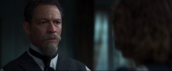 Movie still from “Colette” (2018), directed by Wash Westmoreland – A person wearing a suit and tie; Close Up shot, Over the shoulder angle