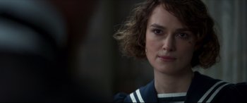 Movie still from “Colette” (2018), directed by Wash Westmoreland – A person wearing a blue and white shirt; Close Up shot, Over the shoulder angle