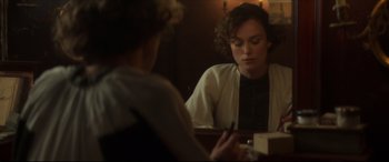 Movie still from “Colette” (2018), directed by Wash Westmoreland – A woman sitting at a table in front of a mirror; Close Up shot, Over the shoulder angle