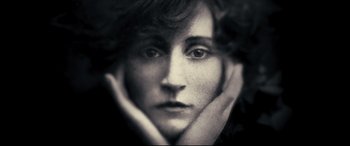 Movie still from “Colette” (2018), directed by Wash Westmoreland – A black - and - white photo of a woman's face; Extreme Close Up shot, Low angle