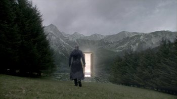 Movie still from “Vikings” (2013), created by Michael Hirst – A man standing in front of an open door in the mountains; Extreme Wide shot, Low angle