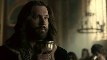 Movie still from “Vikings” (2013), created by Michael Hirst – A man with long hair holding a drink; Close Up shot, Over the shoulder angle