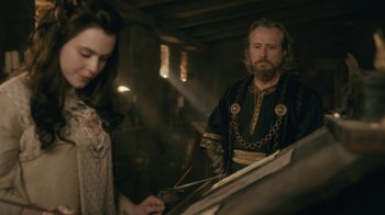 Movie still from “Vikings” (2013), created by Michael Hirst – A man and a woman are standing next to each other; Medium shot, Over the shoulder angle