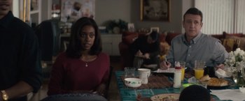 Movie still from “Come Sunday” (2018), directed by Joshua Marston – A woman sitting at a table with a bowl of soup; Medium shot, Over the shoulder angle