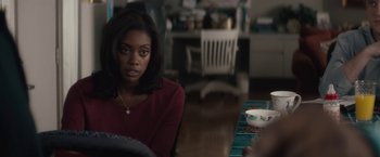 Movie still from “Come Sunday” (2018), directed by Joshua Marston – A woman sitting at a dining room table; Close Up shot, Over the shoulder angle