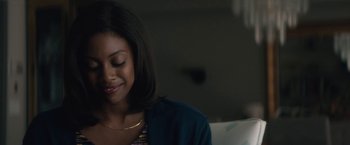 Movie still from “Come Sunday” (2018), directed by Joshua Marston – A person sitting on a couch; Close Up shot, Over the shoulder angle