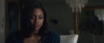 Movie still from “Come Sunday” (2018), directed by Joshua Marston – A person sitting on a couch; Close Up shot, Over the shoulder angle