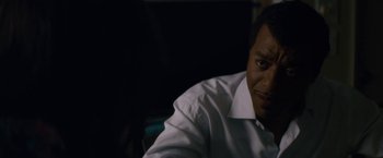 Movie still from “Come Sunday” (2018), directed by Joshua Marston – A person wearing a white shirt; Close Up shot, Over the shoulder angle