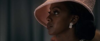 Movie still from “Come Sunday” (2018), directed by Joshua Marston – A person wearing a hat; Close Up shot, Over the shoulder angle