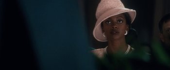 Movie still from “Come Sunday” (2018), directed by Joshua Marston – A person wearing a hat; Close Up shot, Over the shoulder angle