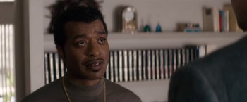 Movie still from “Come Sunday” (2018), directed by Joshua Marston – A person wearing a sweater; Close Up shot, Over the shoulder angle