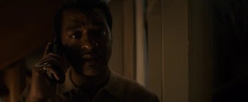 Movie still from “Come Sunday” (2018), directed by Joshua Marston – A person looking at the camera; Close Up shot, Over the shoulder angle