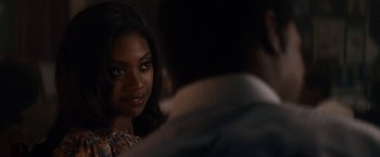 Movie still from “Come Sunday” (2018), directed by Joshua Marston – A woman sitting in front of a man; Close Up shot, Over the shoulder angle