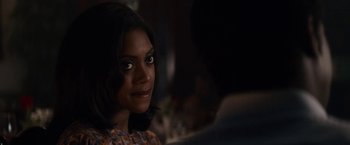 Movie still from “Come Sunday” (2018), directed by Joshua Marston – A person sitting in a room; Close Up shot, Over the shoulder angle