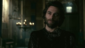 Movie still from “Vikings” (2013), created by Michael Hirst – A man with long hair and a beard is looking at the camera; Close Up shot, Over the shoulder angle