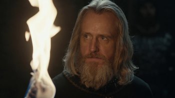 Movie still from “Vikings” (2013), created by Michael Hirst – A man with long hair and a long beard; Close Up shot, Over the shoulder angle