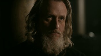 Movie still from “Vikings” (2013), created by Michael Hirst – A person with long hair and a beard; Close Up shot, Low angle
