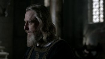 Movie still from “Vikings” (2013), created by Michael Hirst – A man with long white hair and a long beard; Close Up shot, Over the shoulder angle