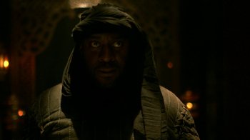 Movie still from “Vikings” (2013), created by Michael Hirst – A man wearing a hood and looking at the camera; Close Up shot, Low angle